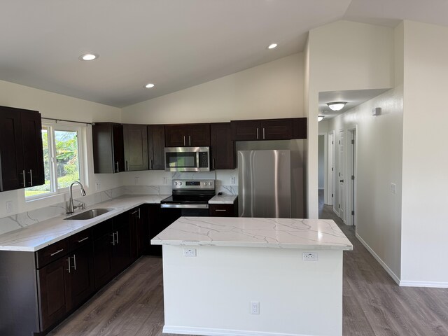 16-2051 Hale Way, Pahoa, HI 96778 - kitchen featuring appliances with stainless steel finishes, light wood-style flooring, a kitchen island, light stone counters, and recessed lighting