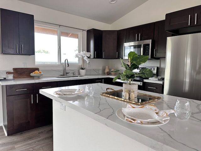 16-2051 Hale Way, Pahoa, HI 96778 - kitchen featuring appliances with stainless steel finishes, lofted ceiling, light stone countertops, and light wood-type flooring