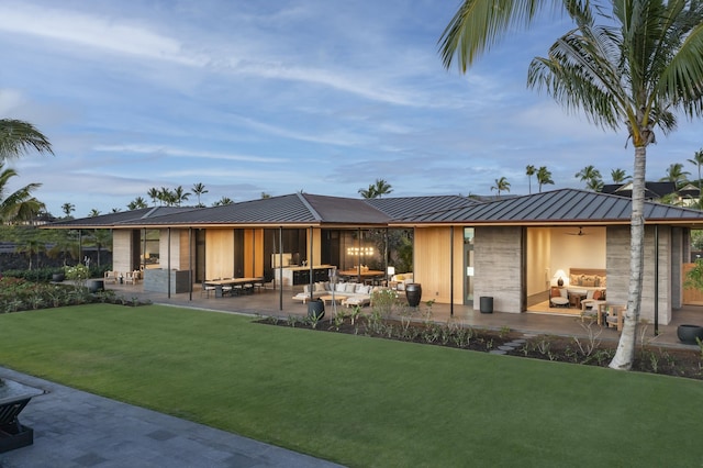 73-2210 Ala Kohanaiki, Kailua Kona, HI 96740 - back of house with a standing seam roof, a patio area, ceiling fan, metal roof, and a lawn