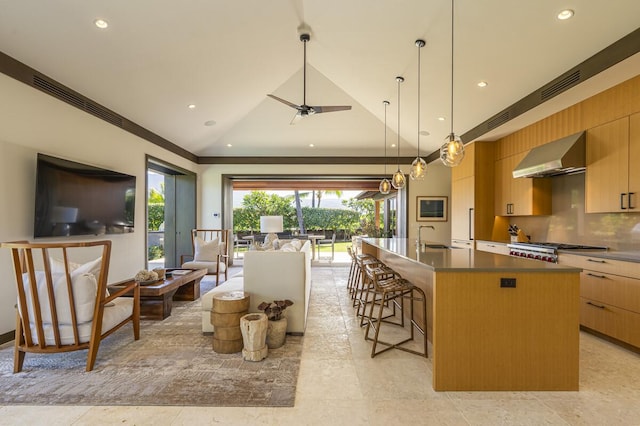 73-4461 Lemi Pl Unit 38, Kailua Kona, HI 96740 - kitchen with wall chimney exhaust hood, open floor plan, modern cabinets, recessed lighting, and a center island with sink
