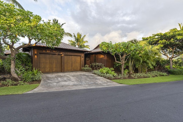 73-4461 Lemi Pl Unit 38, Kailua Kona, HI 96740 - view of front of house featuring a garage, driveway, a standing seam roof, and metal roof