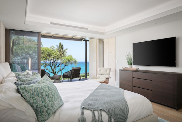66-84 Kaunaoa Dr Unit C33, Kamuela, HI 96743 - bedroom featuring floor to ceiling windows, access to exterior, a tray ceiling, and light wood-style flooring
