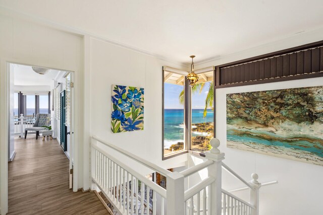 1711 Pee Rd, Koloa, HI 96756 - hallway with an upstairs landing, wood finished floors, and a water view