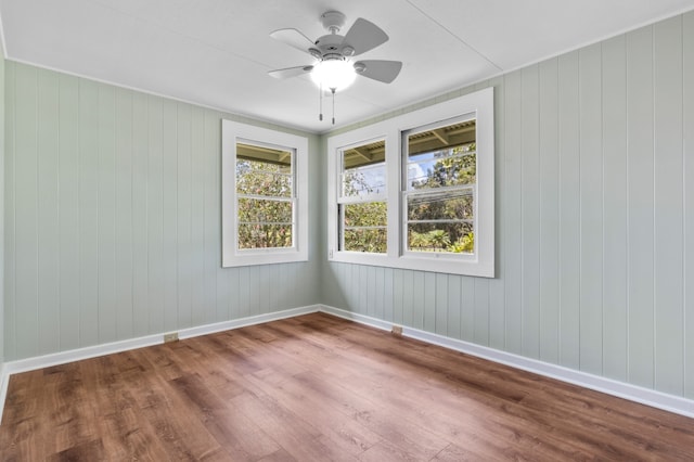 217 Haihai St, Hilo, HI 96720 - unfurnished room with wood finished floors, ceiling fan, and wooden walls