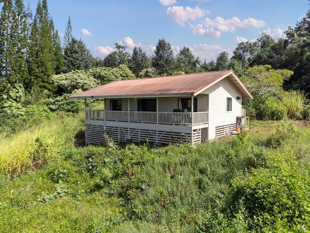 89-1444 Anapuka Rd, Captain Cook, HI 96704 - view of front of house with metal roof and a view of trees