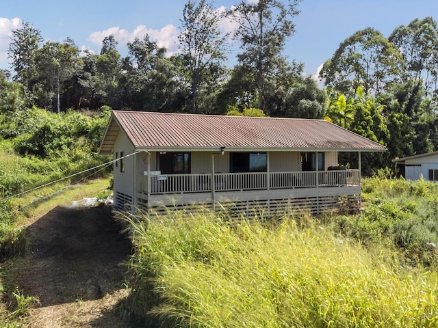 89-1444 Anapuka Rd, Captain Cook, HI 96704 - view of front of home featuring metal roof and view of wooded area