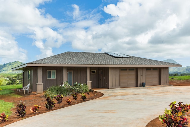 4737-C Koloa Rd Unit 6, Koloa, HI 96756 - view of front of house with board and batten siding, solar panels, roof with shingles, and driveway