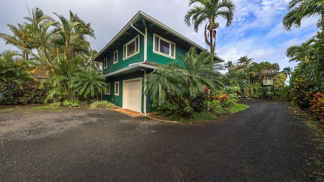 5390 Weke Rd, Hanalei, HI 96722 - view of front of house featuring asphalt driveway and a garage