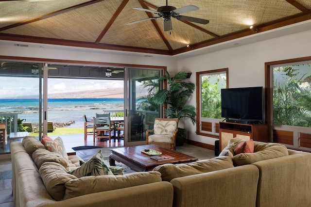 69-1648 Puako Beach Dr, Kamuela, HI 96743 - living area with a ceiling fan, a water view, healthy amount of natural light, lofted ceiling, and baseboards