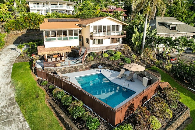 77-6469 Marlin Rd, Kailua-Kona, HI 96740 - rear view of house featuring a fenced backyard, a patio, a sunroom, stairway, and outdoor dining area