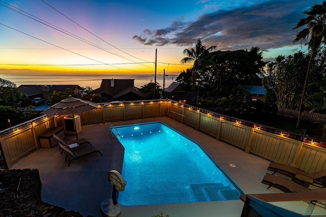 77-6469 Marlin Rd, Kailua-Kona, HI 96740 - pool at dusk with a fenced backyard and a patio area