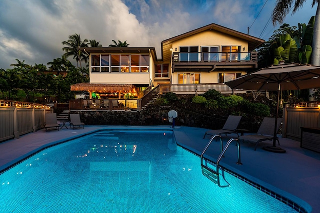 77-6469 Marlin Rd, Kailua-Kona, HI 96740 - rear view of house featuring a balcony, stairway, a patio area, a sunroom, and stucco siding