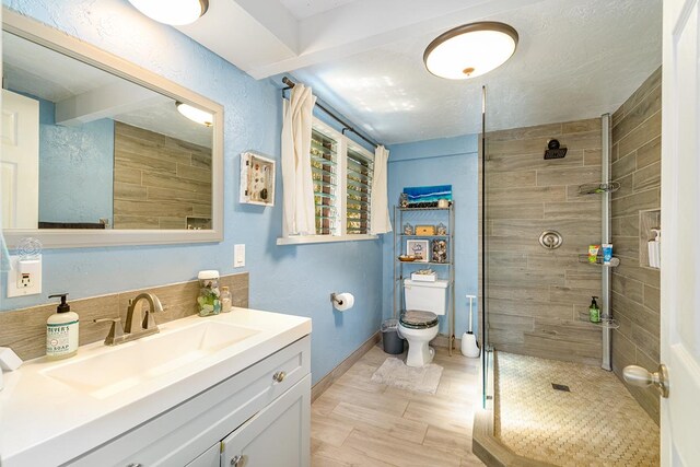 77-6469 Marlin Rd, Kailua-Kona, HI 96740 - bathroom with vanity, tiled shower, toilet, and baseboards
