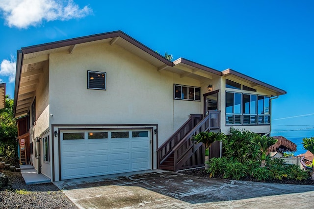77-6469 Marlin Rd, Kailua-Kona, HI 96740 - view of front facade featuring stucco siding, a garage, concrete driveway, and stairway