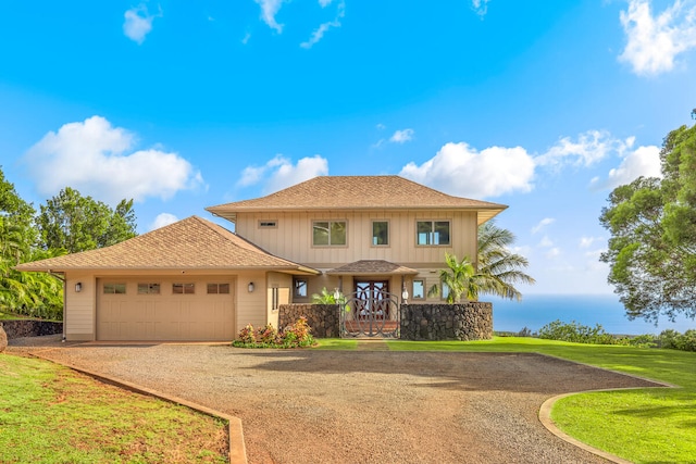 1001-L Puu Rd Unit 2, Kalaheo, HI 96741 - view of front of property featuring dirt driveway, an attached garage, a front lawn, board and batten siding, and a shingled roof