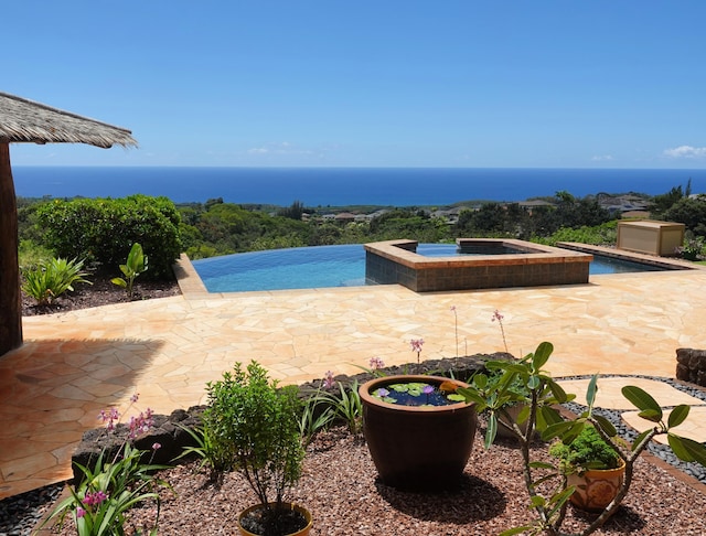 1001-L Puu Rd Unit 2, Kalaheo, HI 96741 - view of swimming pool with a patio, a pool with connected hot tub, and a water view