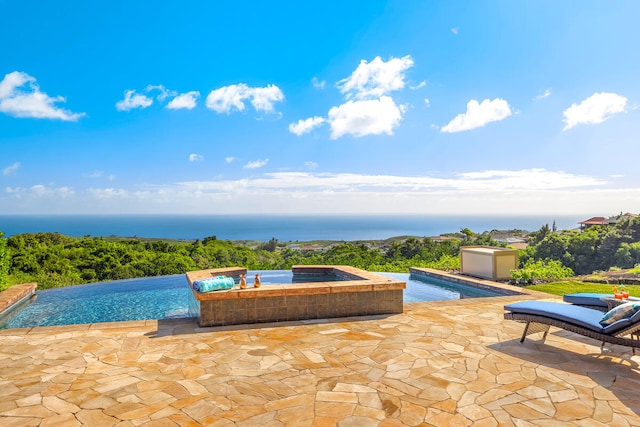 1001-L Puu Rd Unit 2, Kalaheo, HI 96741 - view of pool with a hot tub, a patio area, an infinity pool, and a water view