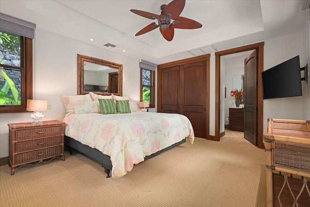 78-7024 Ola Mau St, Kailua-Kona, HI 96740 - bedroom with light colored carpet, a tray ceiling, a closet, ceiling fan, and recessed lighting
