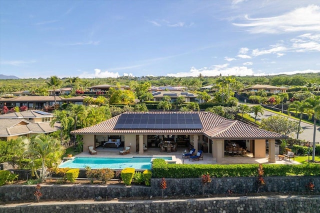 78-7024 Ola Mau St, Kailua-Kona, HI 96740 - rear view of house with solar panels, a tile roof, a patio, stucco siding, and an outdoor living space
