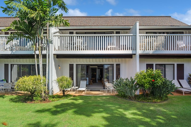 2253 Poipu Rd Unit 101, Koloa, HI 96756 - rear view of house with a balcony and a yard