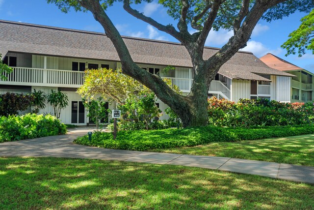 2253 Poipu Rd Unit 101, Koloa, HI 96756 - townhome / multi-family property with a front lawn, a shingled roof, and board and batten siding