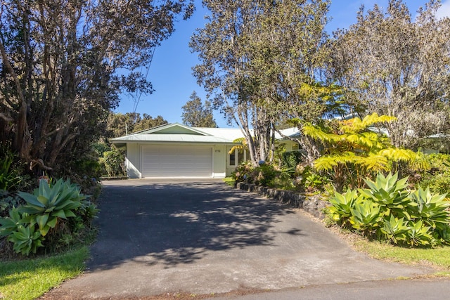 99-1775 Pukeawe Cir, Volcano, HI 96785 - view of front of home featuring driveway and a garage