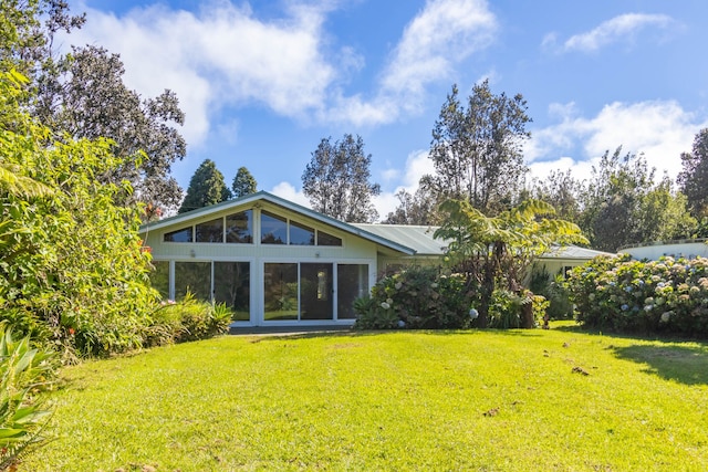 99-1775 Pukeawe Cir, Volcano, HI 96785 - rear view of property featuring a lawn and metal roof