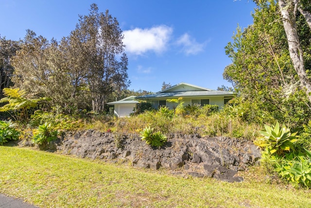 99-1775 Pukeawe Cir, Volcano, HI 96785 - view of side of property featuring an attached garage