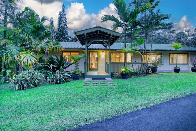 13-979 Kahukai St, Pahoa, HI 96778 - view of front of house with a front yard, metal roof, and covered porch