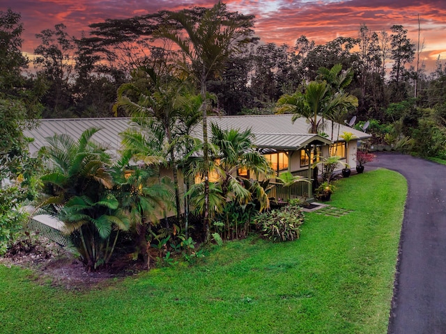 13-979 Kahukai St, Pahoa, HI 96778 - view of front of house with a yard, metal roof, a standing seam roof, and view of wooded area