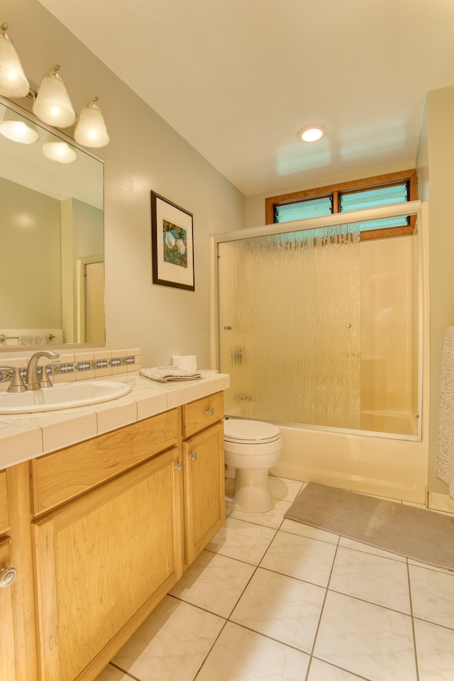 13-979 Kahukai St, Pahoa, HI 96778 - full bathroom with vanity, tile patterned floors, toilet, and bath / shower combo with glass door