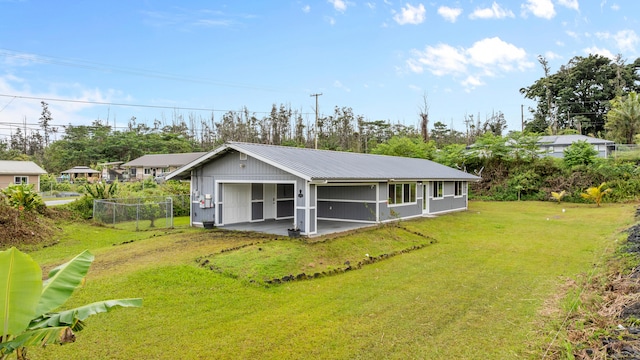 16-2170 Treefern Dr, Pahoa, HI 96778 - view of front of property with metal roof, a garage, a patio, and view of scattered trees