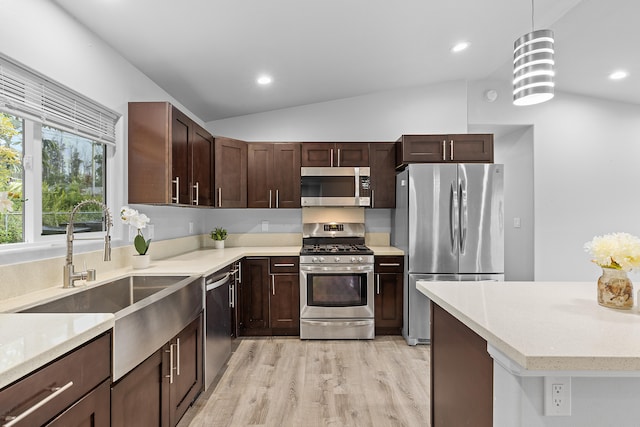 16-2170 Treefern Dr, Pahoa, HI 96778 - kitchen with stainless steel appliances, lofted ceiling, a sink, light wood-style floors, and hanging light fixtures
