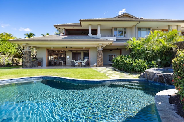 62-3979 Kaunaoa Iki Rd Unit 2A, Kamuela, HI 96743 - rear view of house with ceiling fan, stucco siding, a balcony, a lawn, and a patio area