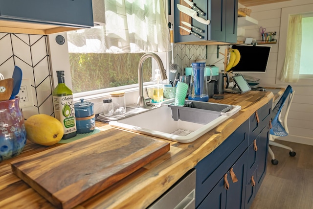 16-1961 Silversword Ct, Pahoa, HI 96778 - kitchen with wooden counters, a sink, wood finished floors, blue cabinetry, and decorative backsplash