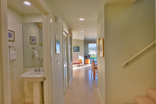 78-6833 Alii Dr Unit E5, Kailua-Kona, HI 96740 - hallway with light tile patterned flooring, baseboards, recessed lighting, stairway, and a sink