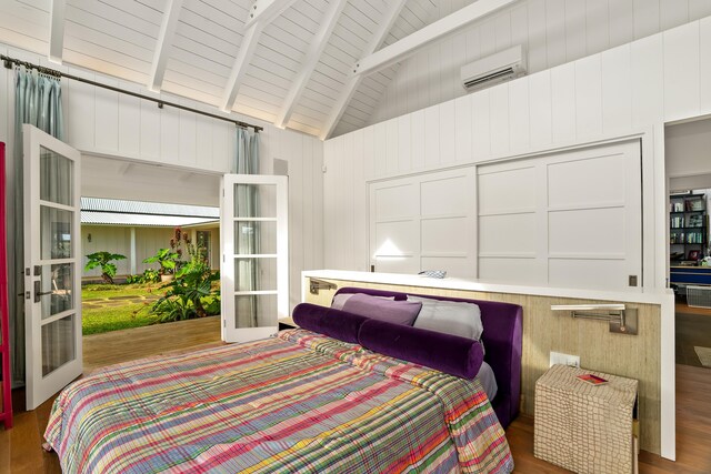 7465-C Koolau Rd, Kilauea, HI 96754 - bedroom with an AC wall unit, wood finished floors, french doors, high vaulted ceiling, and wood ceiling with exposed beams