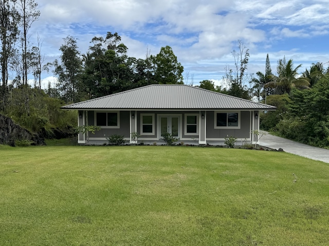 15-2797 Lai St, Pahoa, HI 96778 - view of front of house featuring french doors, a front lawn, and metal roof