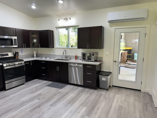 15-2797 Lai St, Pahoa, HI 96778 - kitchen with stainless steel appliances, a wall mounted air conditioner, a sink, light countertops, and light wood finished floors