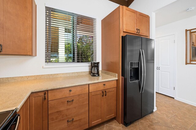 78-6800 Alii Dr Unit 7304, Kailua-Kona, HI 96740 - kitchen with stainless steel fridge with ice dispenser, black / electric stove, light countertops, light tile patterned floors, and brown cabinets