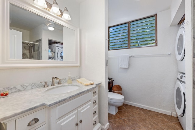 78-6800 Alii Dr Unit 7304, Kailua-Kona, HI 96740 - bathroom with stacked washing machine and dryer, toilet, vanity, baseboards, and a shower with shower door