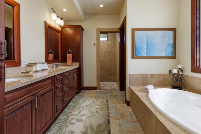 62-3600 Amaui Pl Unit K202, Kamuela, HI 96743 - full bathroom featuring a garden tub, stone tile floors, double vanity, recessed lighting, and a tile shower