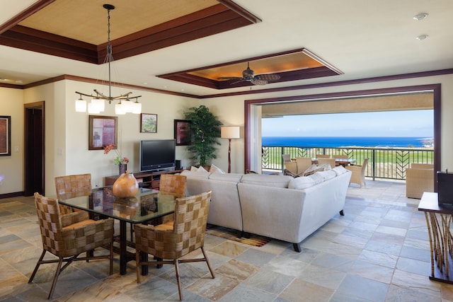 62-3600 Amaui Pl Unit K202, Kamuela, HI 96743 - dining area with a raised ceiling, a ceiling fan, crown molding, a chandelier, and stone finish floors