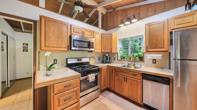 566-A Puuopae Rd, Kapaa, HI 96746 - kitchen featuring appliances with stainless steel finishes, a sink, wooden ceiling, light tile patterned floors, and backsplash