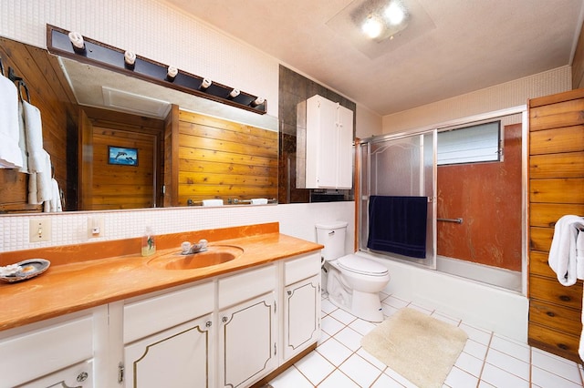 1890 Kaiao St, Hilo, HI 96720 - full bath featuring vanity, tile patterned floors, toilet, combined bath / shower with glass door, and wooden walls