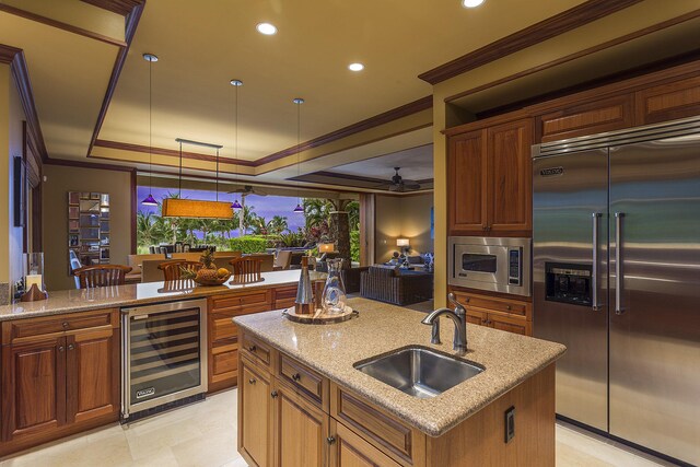 62-3947 Kaunaoa Iki Rd Unit 7A, Kamuela, HI 96743 - kitchen featuring built in appliances, beverage cooler, a sink, a raised ceiling, and crown molding