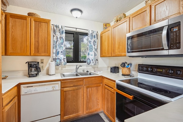 4460 Nehe Rd Unit 116, Lihue, HI 96766 - kitchen featuring dishwasher, range with electric cooktop, stainless steel microwave, a sink, and a textured ceiling