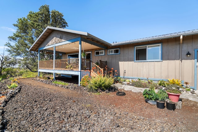 92-8227 Trade Wind Blvd, Ocean View, HI 96737 - view of front of house with board and batten siding and a wooden deck