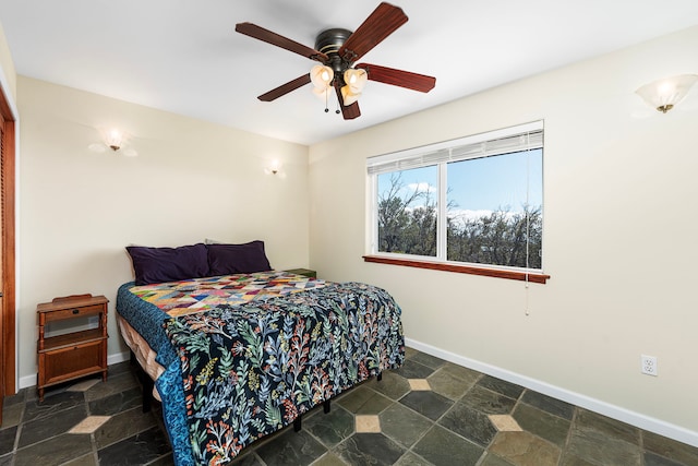 92-8227 Trade Wind Blvd, Ocean View, HI 96737 - bedroom featuring stone finish floors, baseboards, and a ceiling fan