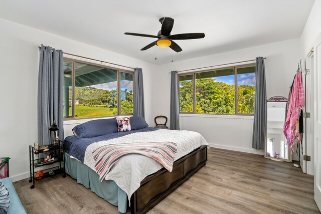6421-L Hauiki Rd, Kapaa, HI 96746 - bedroom with light wood finished floors, baseboards, and ceiling fan